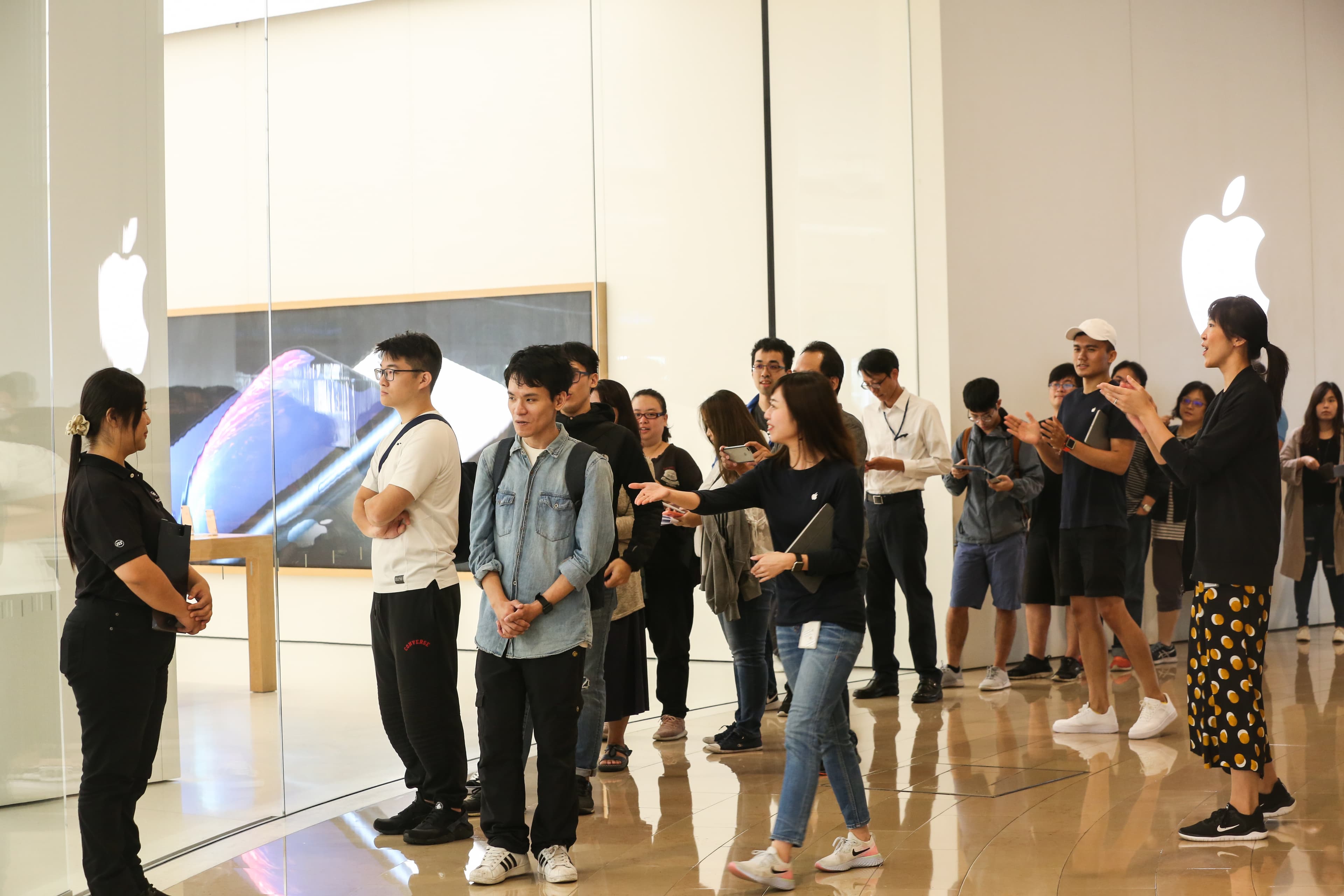 死忠果粉們在Apple Store台北101直營門市店員擊掌簇擁下正式登門。