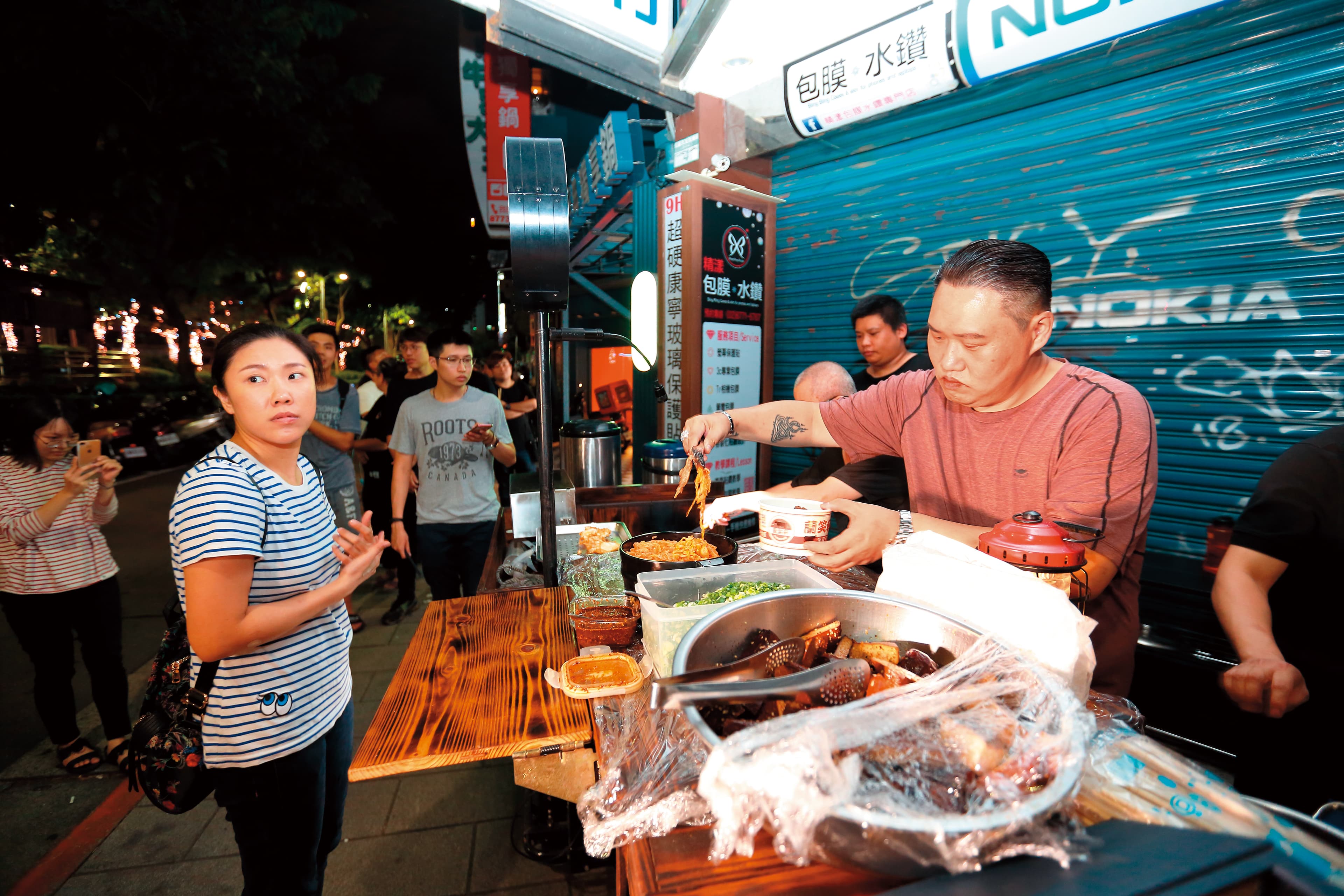 每週五、六深夜，蘭小明（右）在台北東區巷弄以攤車形式，販售深夜限定的蘭笑軒和牛滷肉飯。左為妻子黃麗錦。
