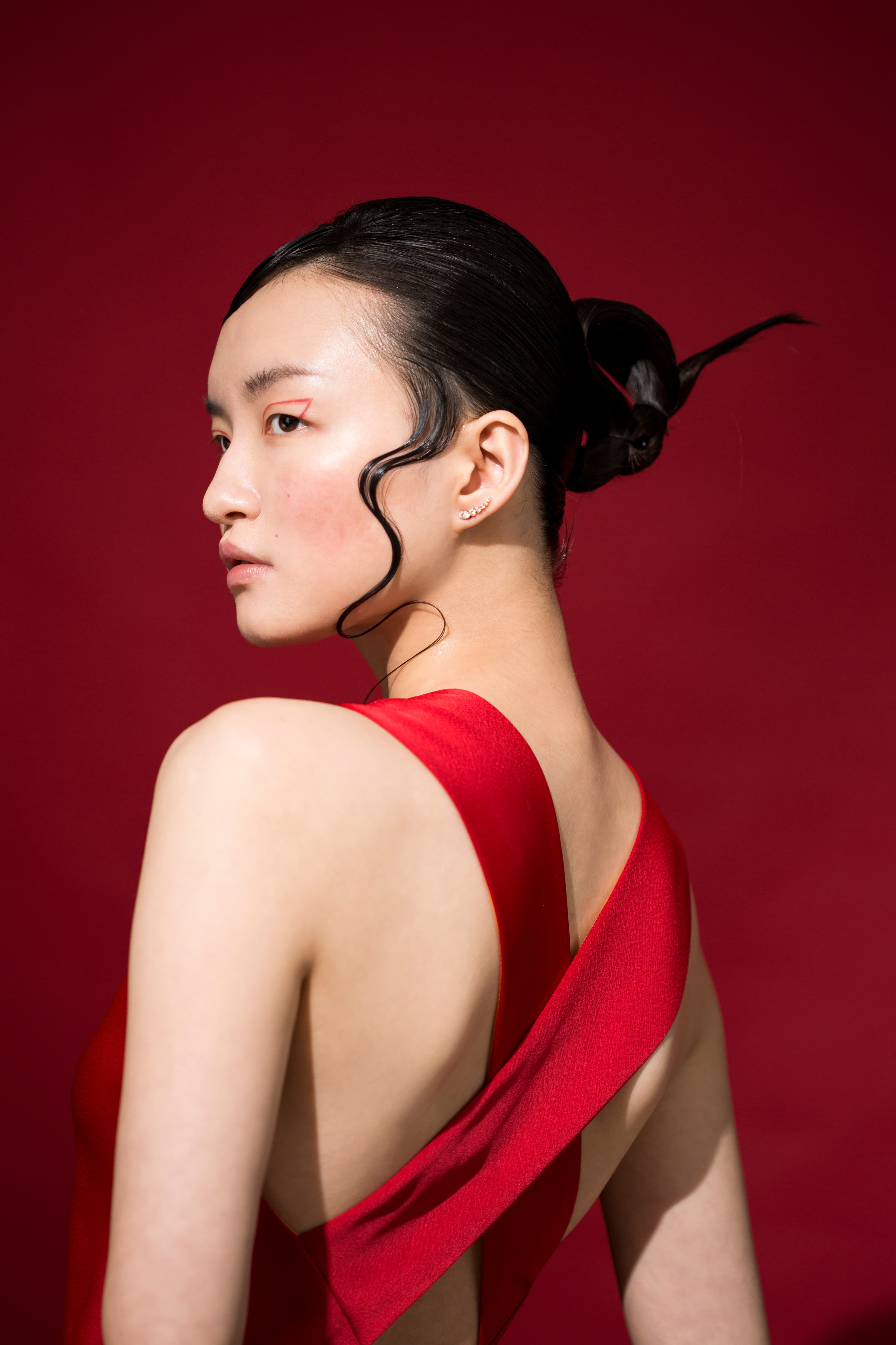 紅色深V背後交叉禮服 NT$42,800 by PAUL SMITH MOONSUN／穿孔耳環 NT$4,490 by SWAROVSKI