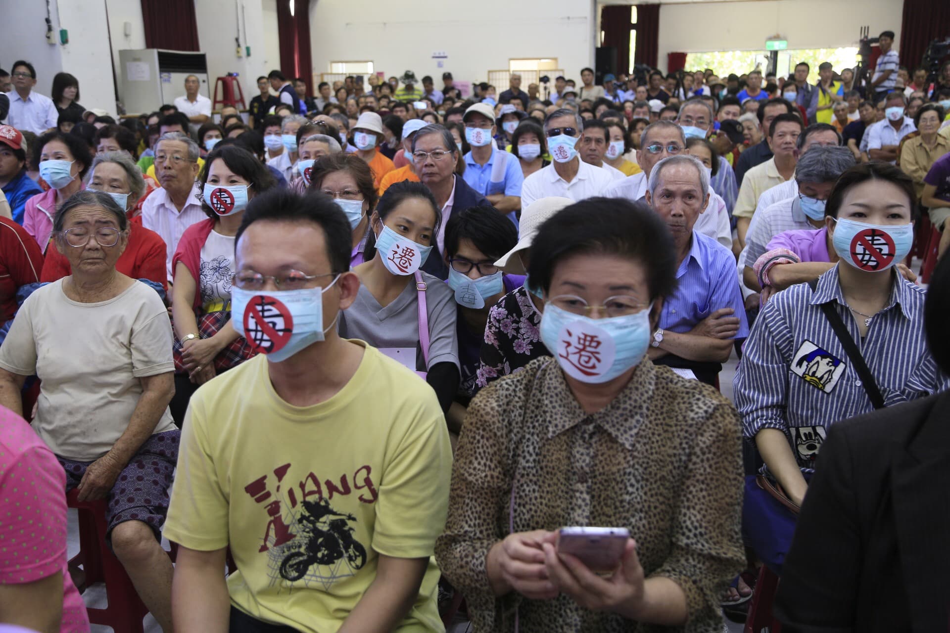 2016年，時任行政院長林全與高雄市長陳菊前往大林蒲鞠躬道歉，並開座談會傾聽民意，當地居民戴上口罩抗議環境汙染。（中央社）