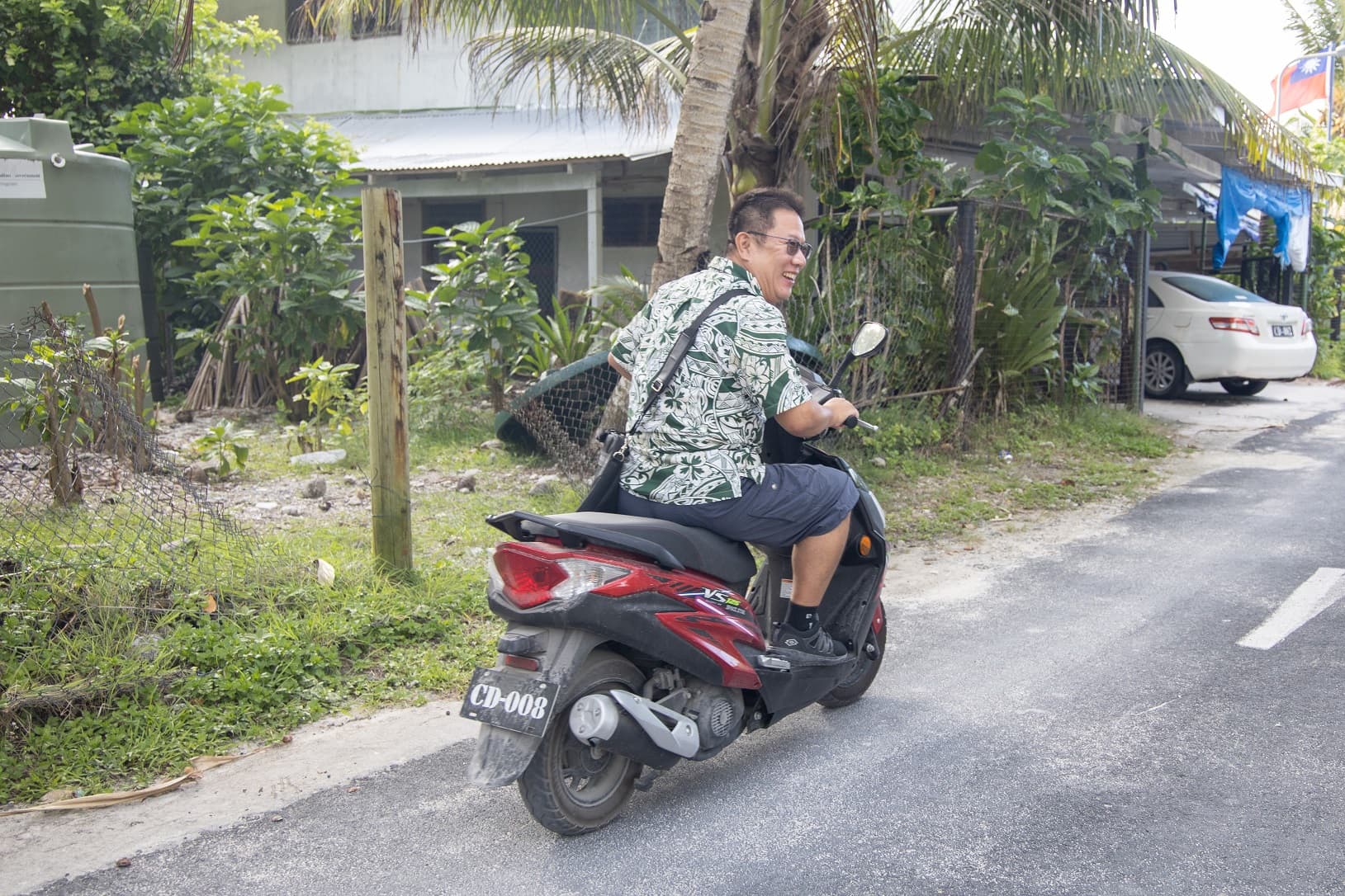 副參事盧明然騎乘大使館的外交公務車，竟然是機車。