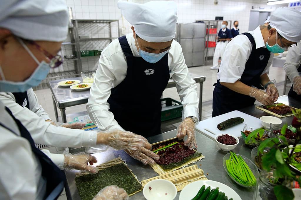 花蓮慈濟醫院院長林欣榮（中）做起蔬食料理頗有大廚架勢。（慈濟基金會提供）