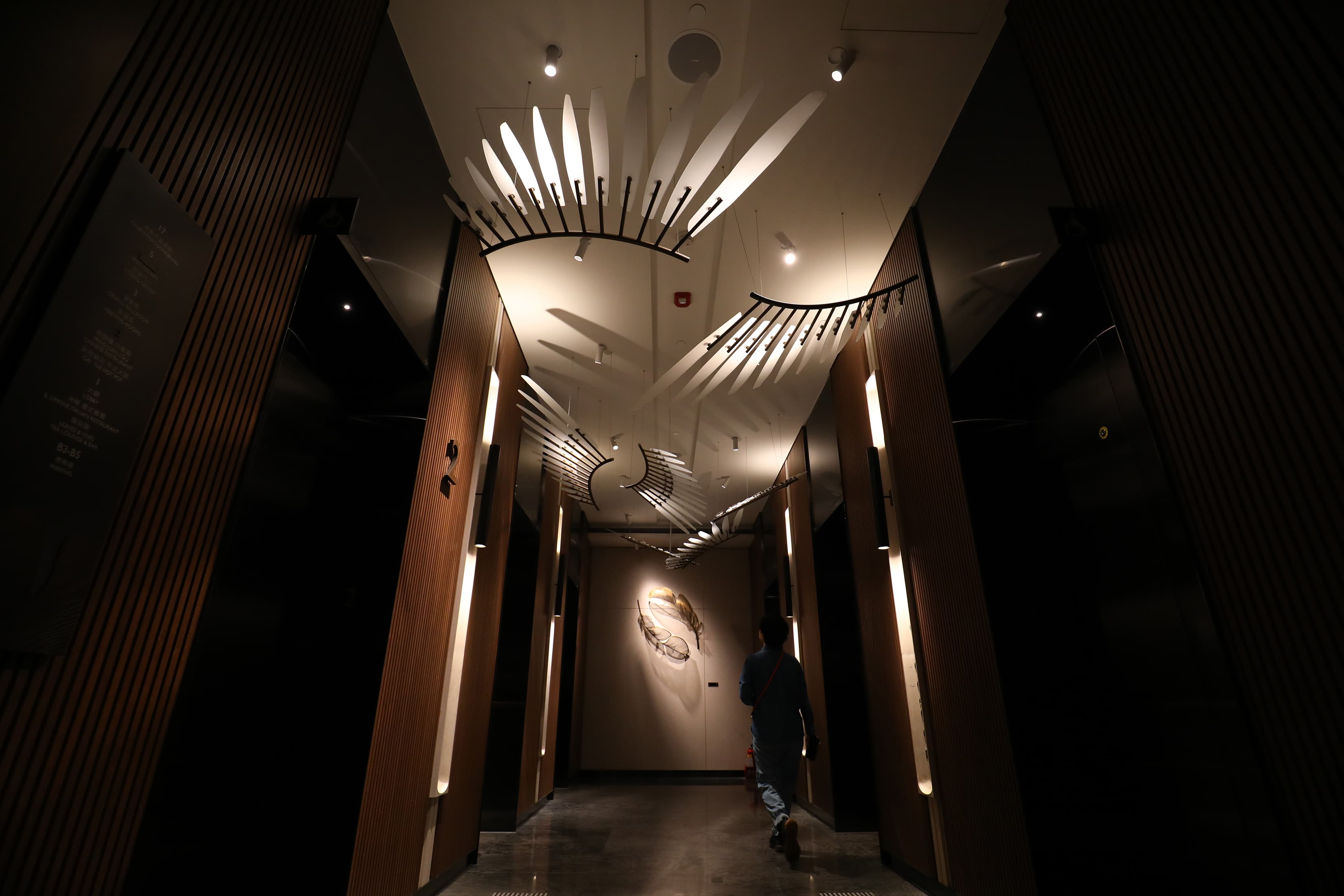 2樓梯廳的大型藝術作品《落羽》，以黃銅鏤空鍛敲技法，塑造出兩片輕盈而優雅的巨型羽毛。