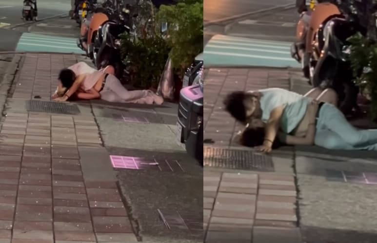 一對男女躺在人行道上，以男上女下姿勢激吻。（翻攝臉書社團「爆廢公社」）