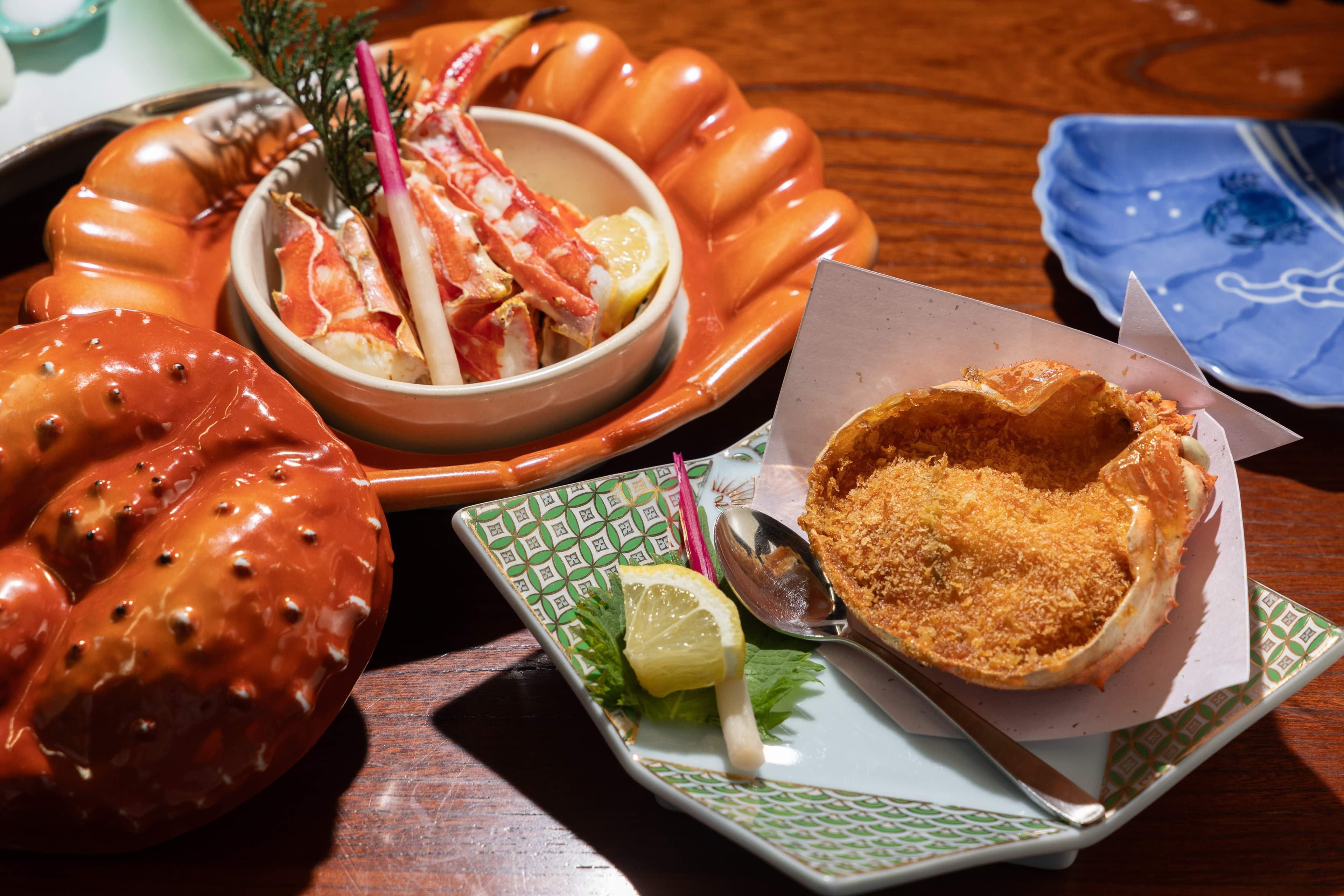 「本タラバかに宝楽焼き」(左,5,300日圓/個,約NT$1,036)使用寶樂燒連殼燒烤帝王蟹;「特撰かに甲羅揚げ」(右,1,650日圓/個,約NT$323)將蟹肉、魚漿、蝦漿混合後油炸。